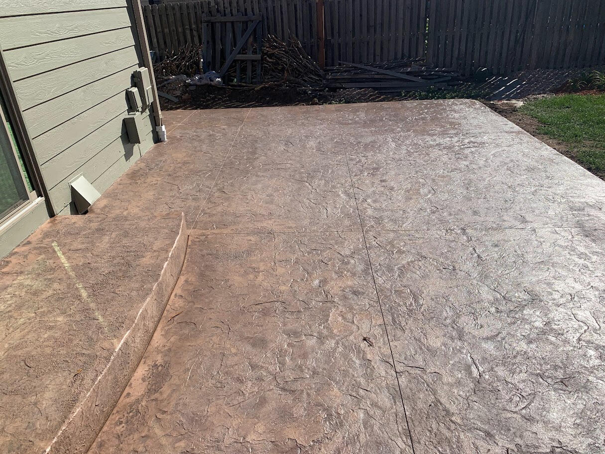 Close-up of stamped concrete patio in Fort Collins, CO showing detailed texture and color variation for a natural stone look