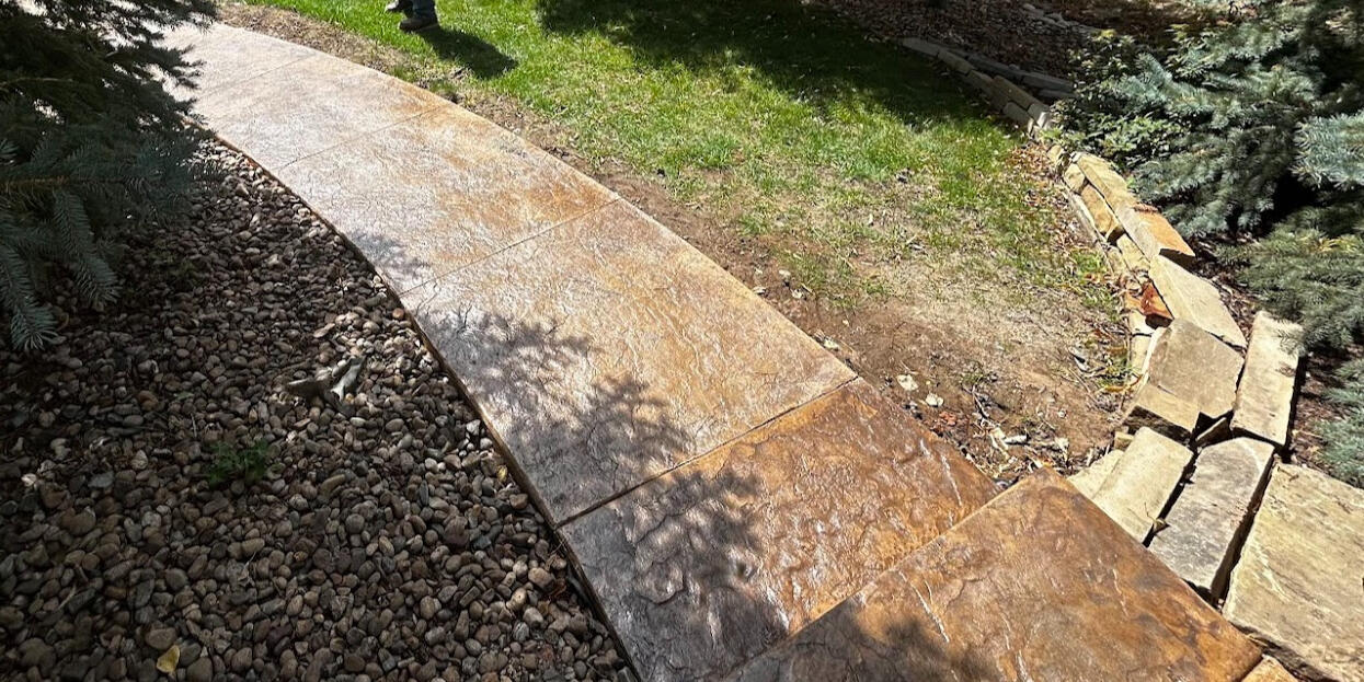 Close-up of stamped concrete walkway in Fort Collins, CO showing detailed texture and color variation for a natural stone appearance