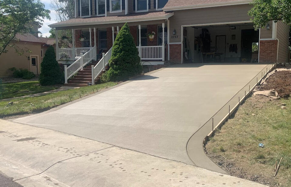 New concrete driveway installation in Fort Collins, CO with a smooth broom finish, designed for durability and curb appeal.