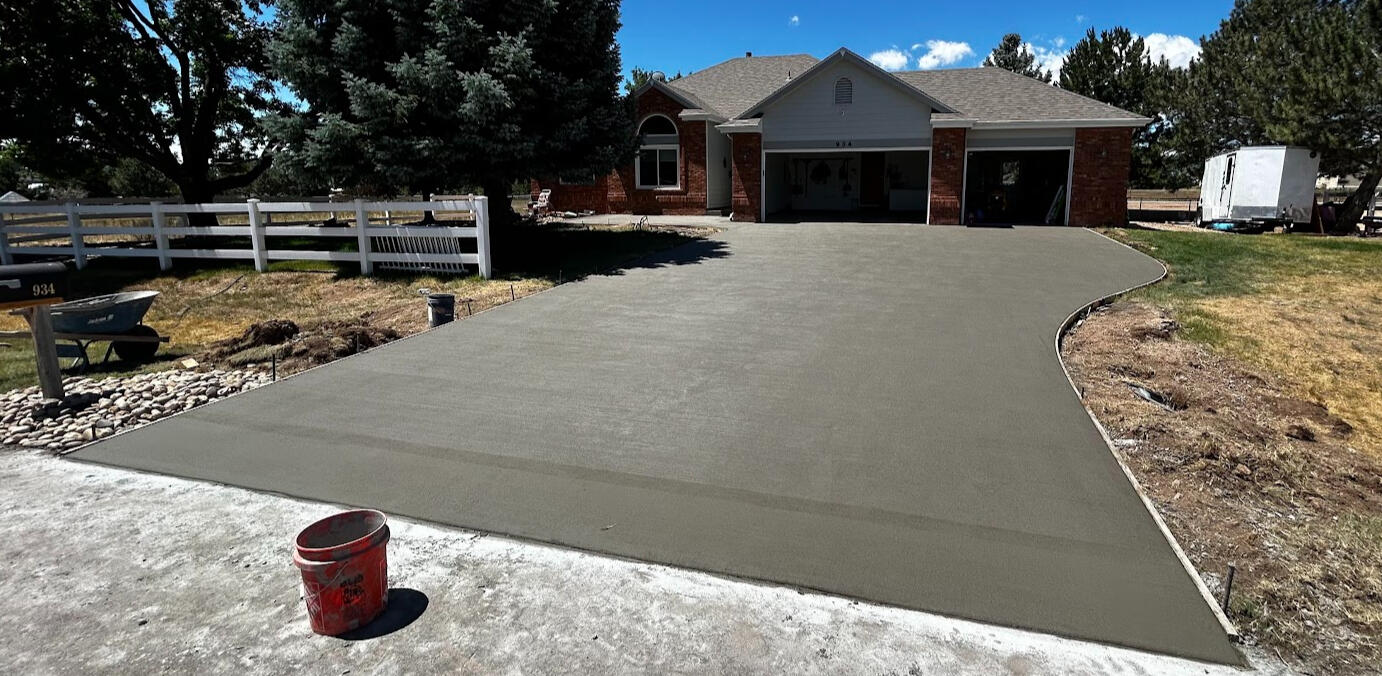Large curved concrete driveway in Severance, CO with a smooth broom finish, providing durable and functional access.