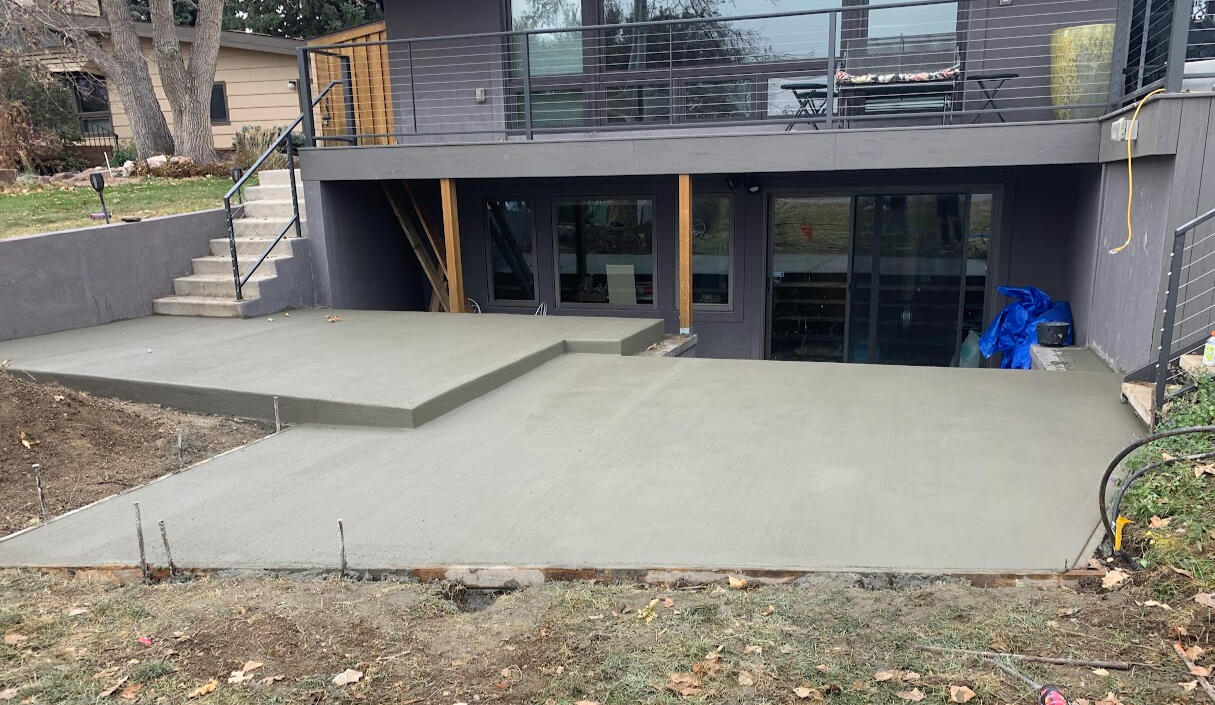 Multi-level concrete patio in Loveland, CO with a smooth broom finish, designed for outdoor living