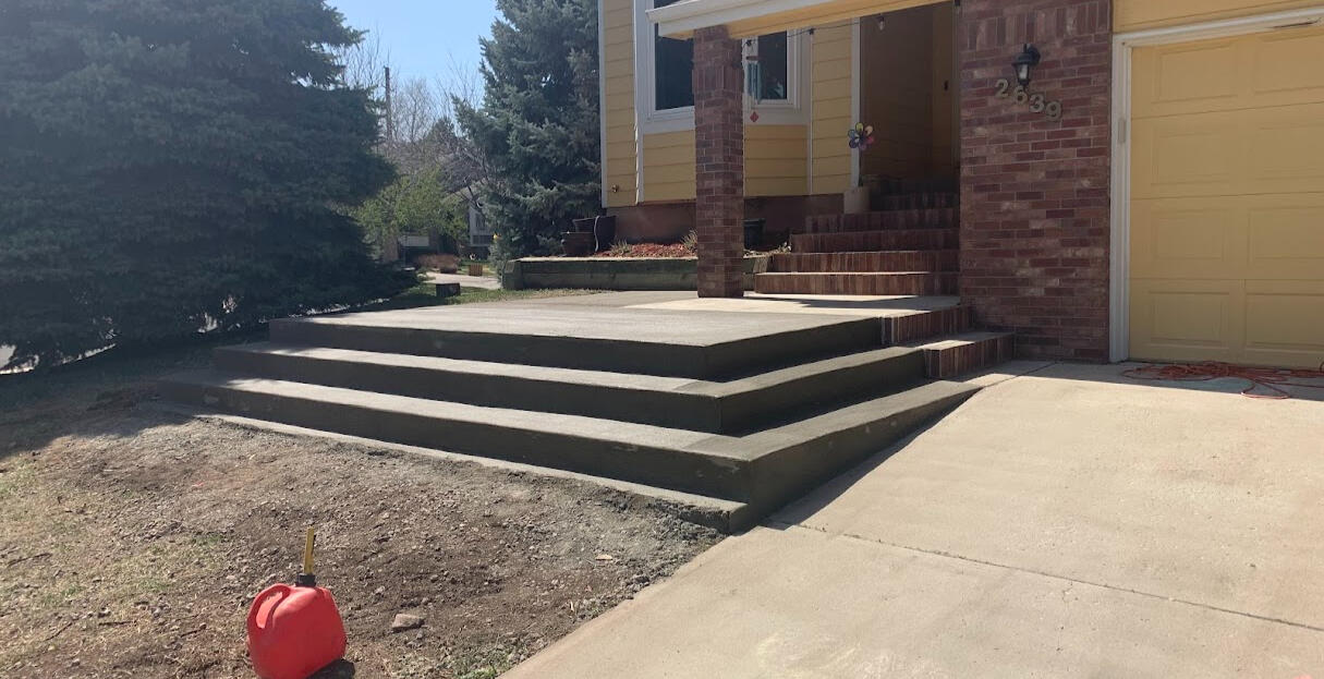 Concrete steps and front entry in Fort Collins, CO with a smooth finish, providing safe and durable access to the home.