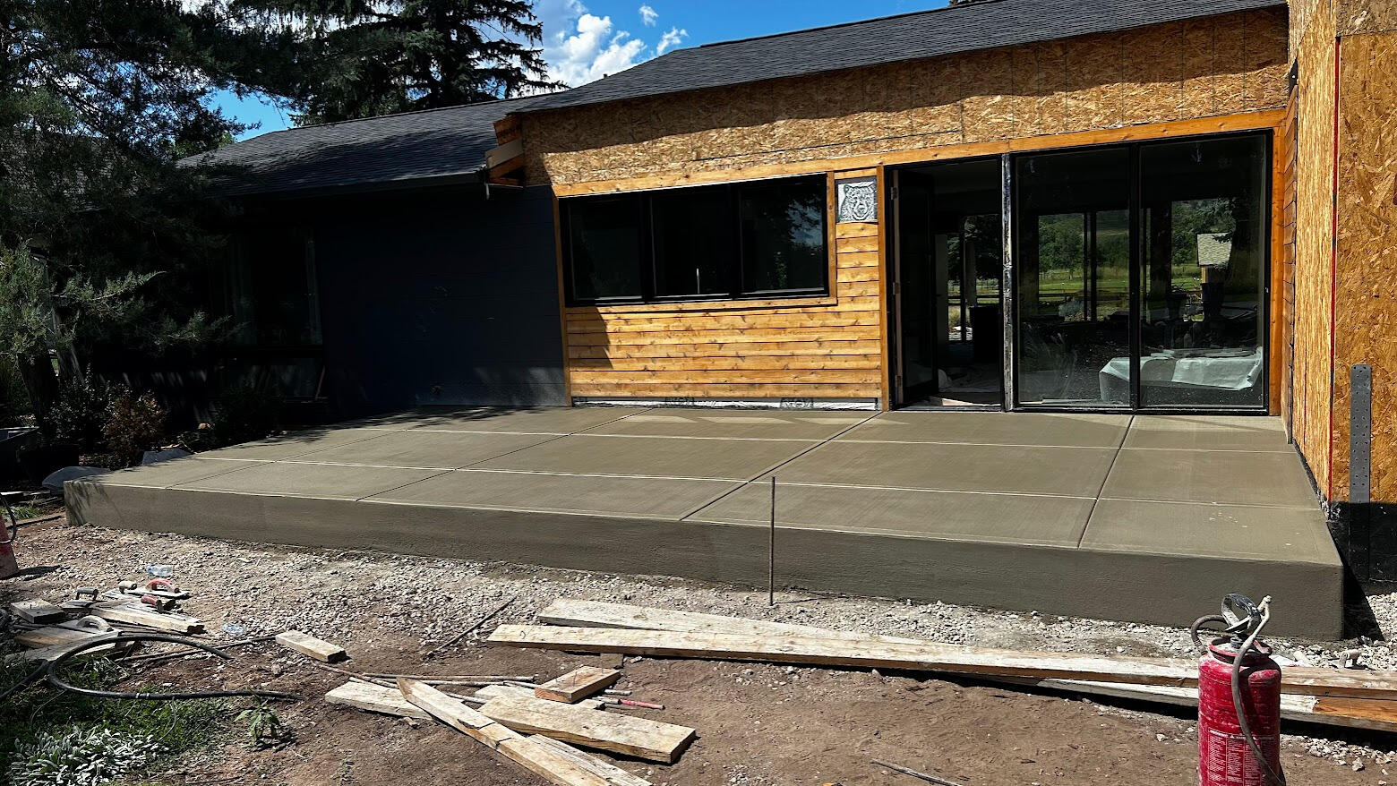 Large concrete patio in Fort Collins, Colorado with a smooth broom finish, installed for durable outdoor living space.