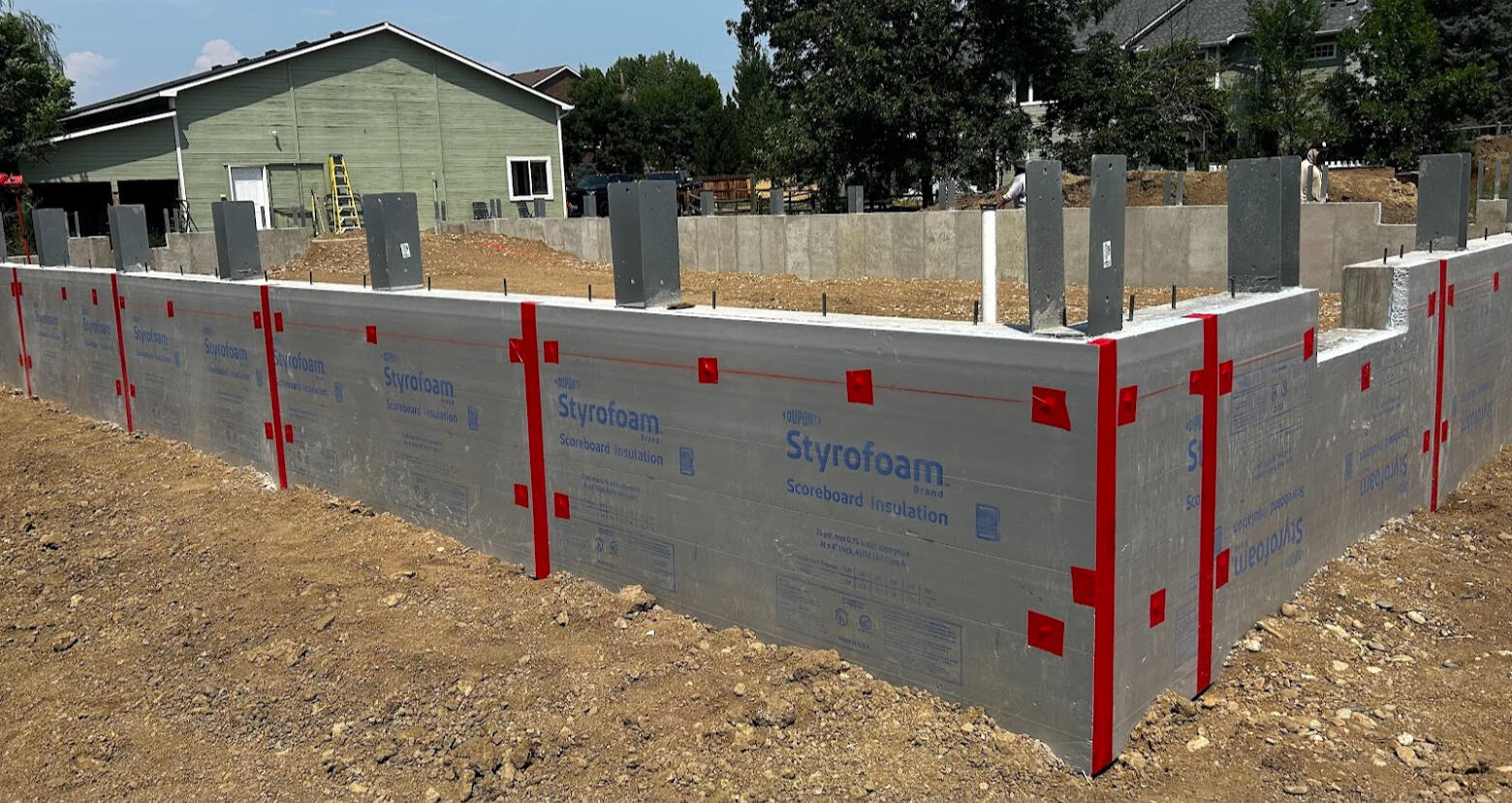 Up-close shot of waterproofed and foam insulated foundation wall to protect wall.
