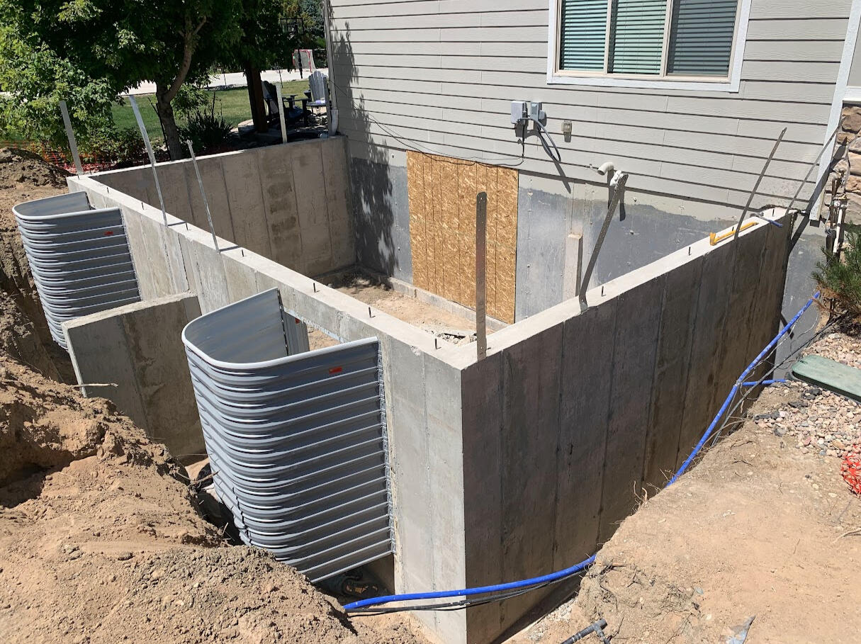 Small house addition requiring a square concrete wall.