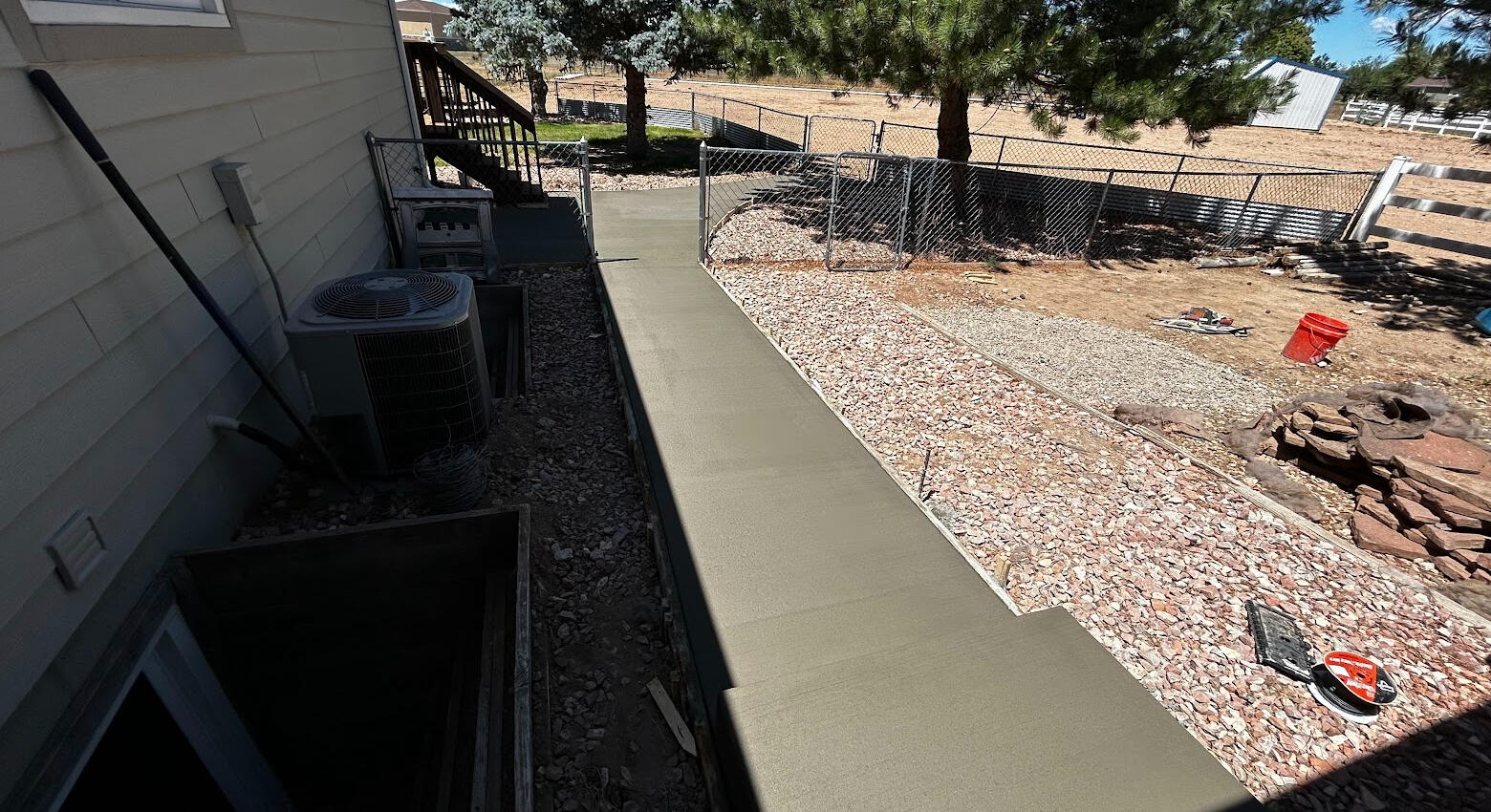 Newly poured straight concrete sidewalk in Severance, CO, leading to back yard.