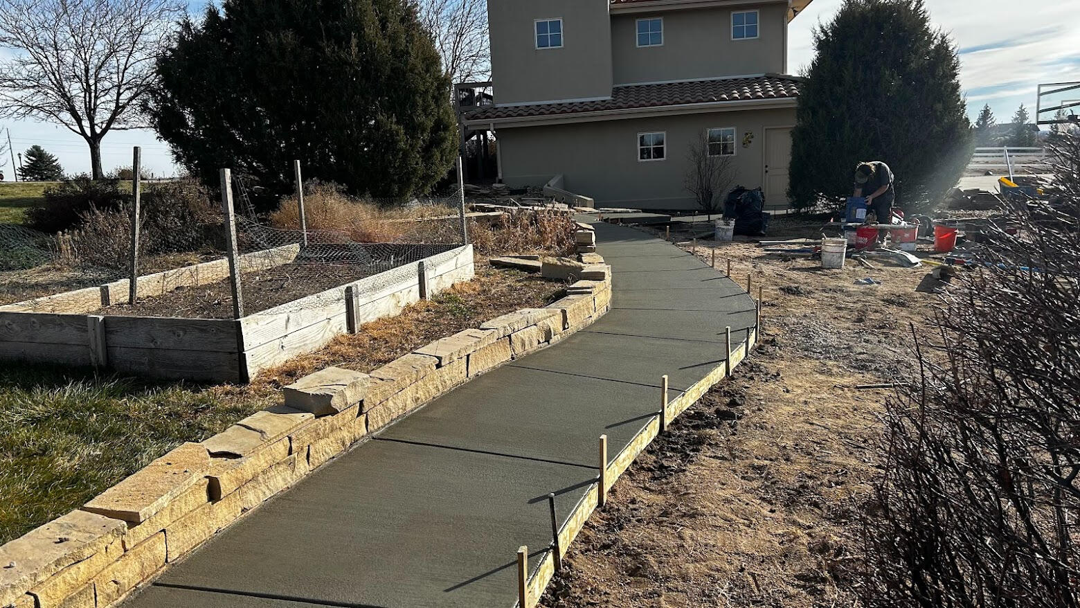 Newly poured curved concrete walkway in Severance, Colorado with smooth broom finish, perfect for walking.