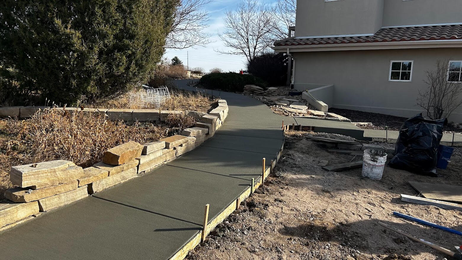 Curved concrete walkway leading to home entrance in Severance, CO with clean finish and integrated step transition