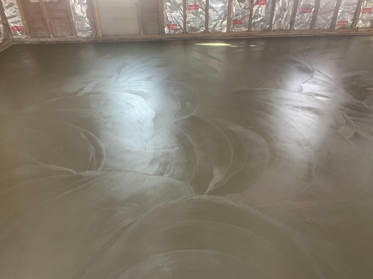 Smooth trowel finish concrete floor in Fort Collins home.