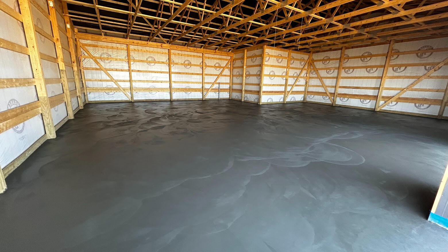 Smooth troweled finish floor inside a post frame barn in Ault, Colorado.