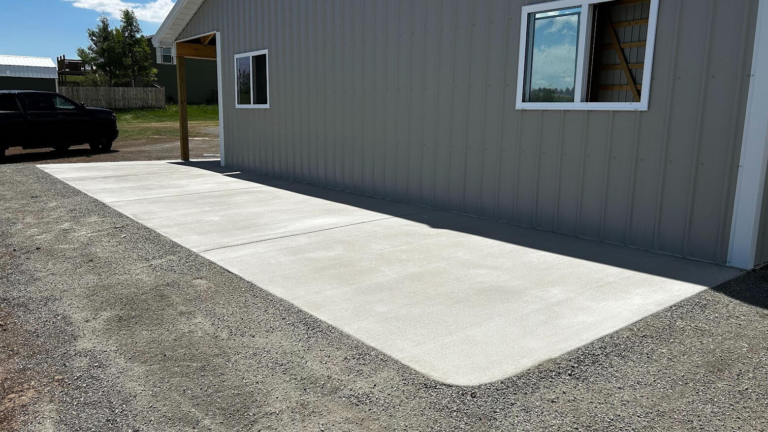 New concrete apron slab along metal building, smooth light finish with clean edges in Cheyenne, Wyoming