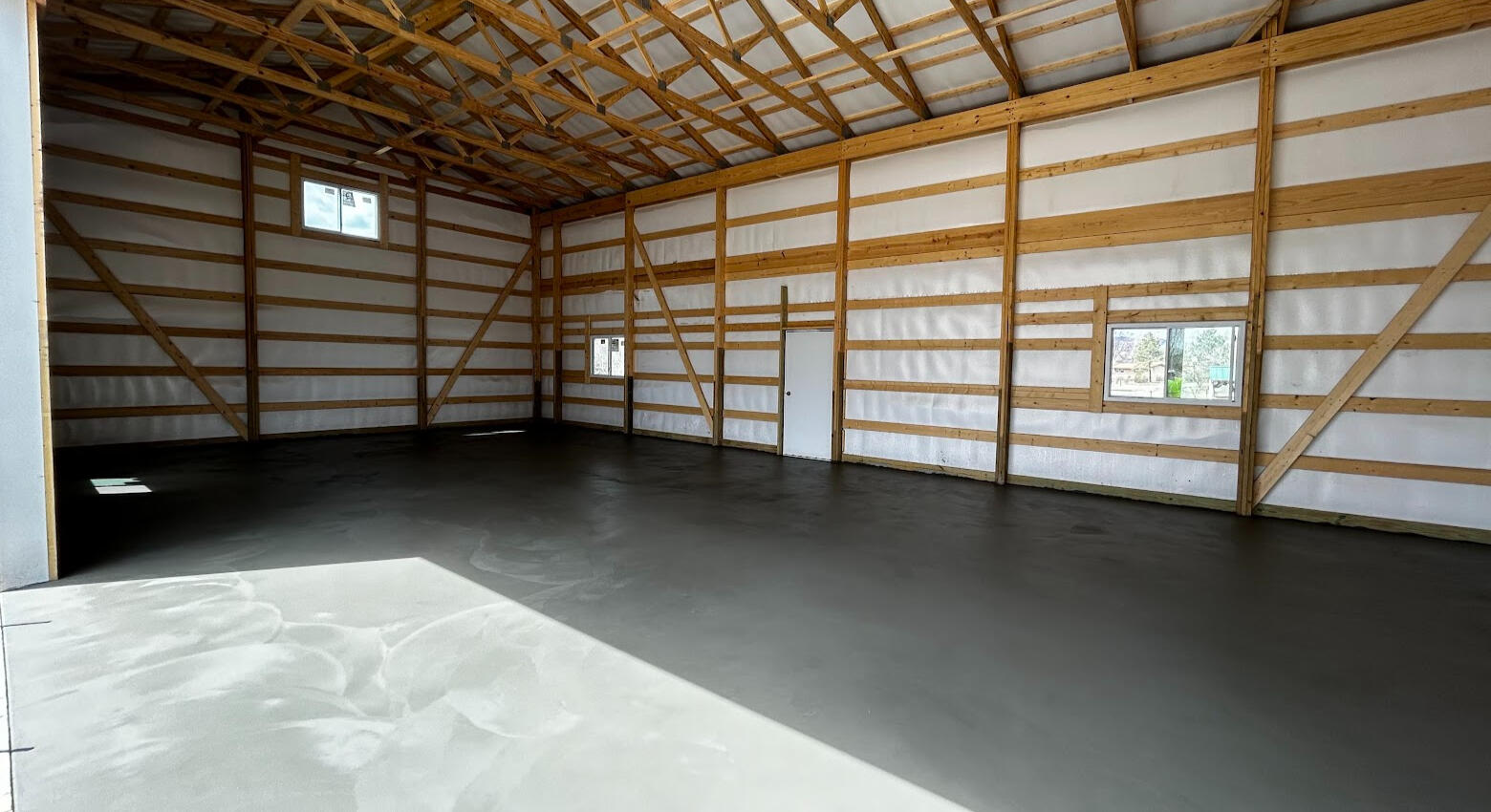 Pole barn concrete floor installation in Northern Colorado with large open shop and smooth finish, in Loveland, CO